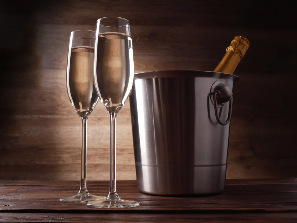 two wine glasses with champagne steel bucket