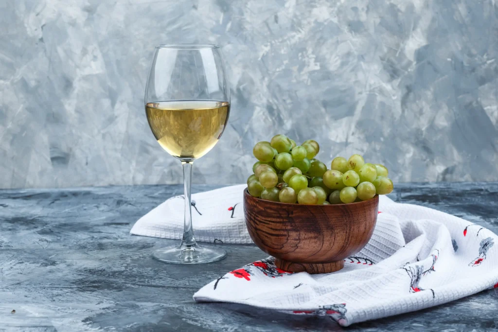 white wine glass with grapes