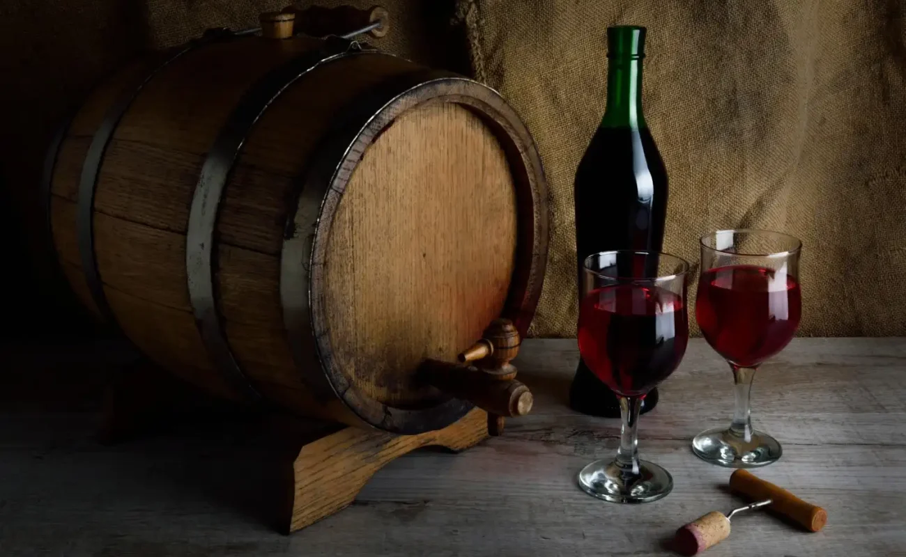 bottle-wine-with-glass-corkscrew-wooden-background