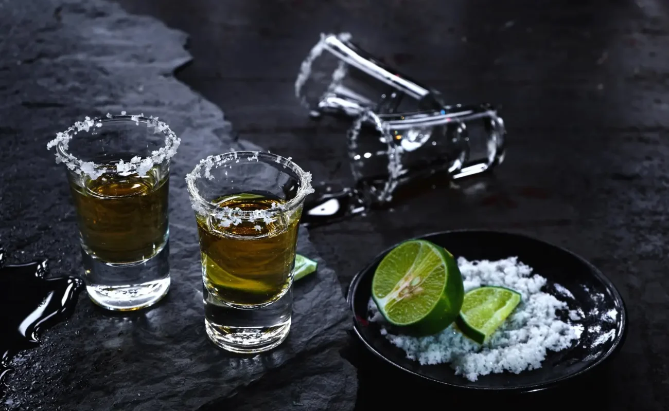 high-angle-view-vodka-shots-by-lime-salt-table