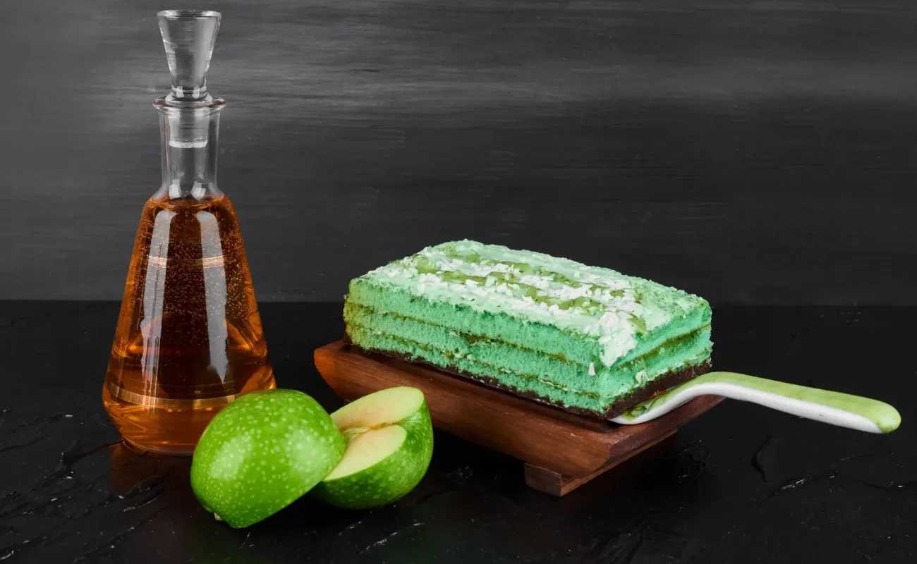 slice-green-cake-with-bottle-cognac slice-green-cake-with-bottle-cognac