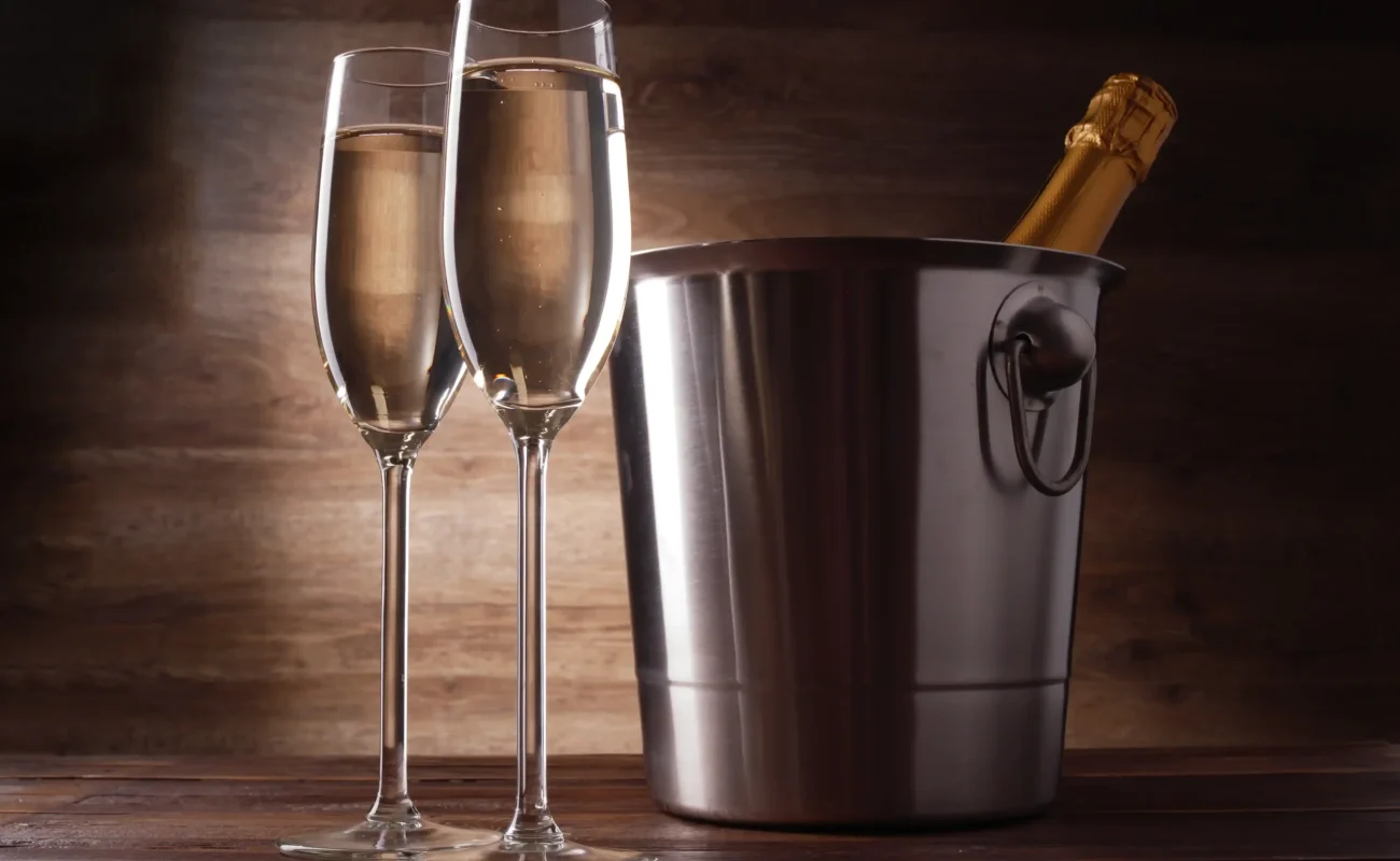 two wine glasses with champagne steel bucket