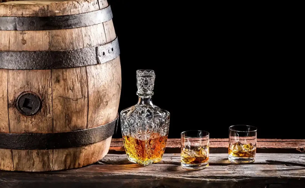 whiskey-barrel-decanter-glasses-rustic-wooden-surface whiskey-barrel-decanter-glasses-rustic-on-wooden-surface