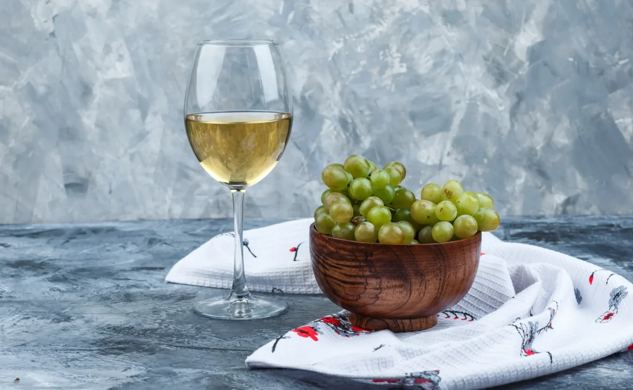 white wine glass with grapes